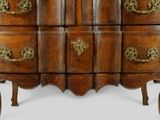 a wooden chest of drawers with brass handles on it