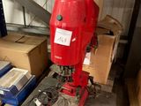 a red machine that is sitting on a pallet