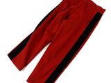 a pair of red pants with black stripes on them