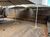 two umbrellas that are sitting on a wooden deck