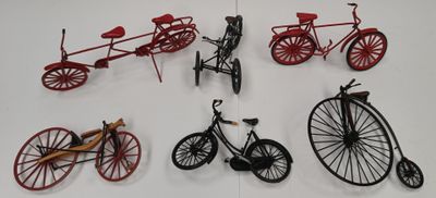 many different types of bicycles on display on a table