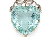 a close up of a heart shaped aquamarine and diamond broochle