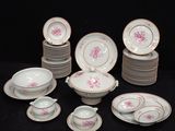many plates and cups and saucers on a table