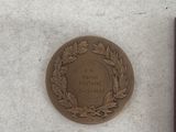 a medal and a medal on a table next to each other