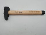 a hammer with a wooden handle sitting on top of a table