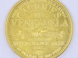 a close up of a gold coin on a white surface