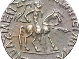an old silver coin with a man on a horse and a woman on a horse