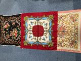 three different types of silk scarves on a blue carpet