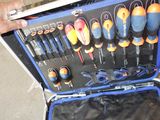 a man holding a tool case full of different tools