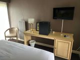 a television on a desk in a hotel room