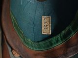 a green hat sitting on top of a wooden table