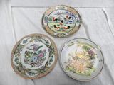 three plates are sitting on a table with a white table cloth