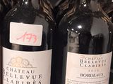 bottles of wine are lined up on a shelf in a store
