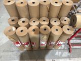 many rolls of brown paper sitting on the floor