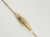 a close up of a gold bracelet with a name engraved on it