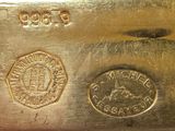 a close up of a gold bar with a stamp on it