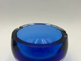 a blue and white glass bowl sitting on top of a table
