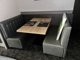a small table and two chairs in the corner of a booth