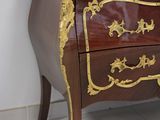 a brown and gold chest of drawers with a marble top