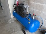 a blue air compressor sitting next to a fire hydrant
