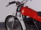 a red and white motorcycle parked in a garage