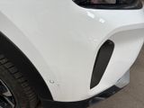a close up of a car ' s front bumper with a sticker on it