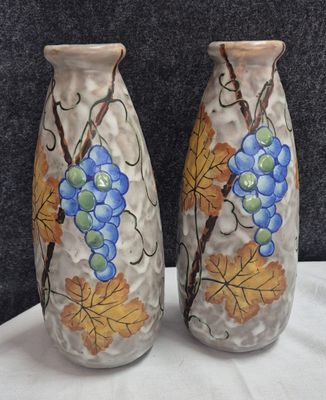 two vases that are painted with grapes on them