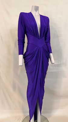 the dress is purple and has a deep v neck and long sleeves