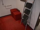 a ladder that is leaning against a wall in a room
