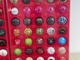 a lot of buttons in a red case on the table