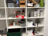 a small kitchen with a sink and shelves in it