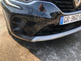 a close up of a car with a dog on the front of it