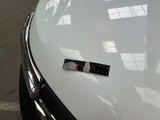 a sticker on the hood of a car that is parked in a parking lot