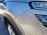 a close up of a car ' s headlight with a reflection on the side of it