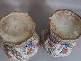 two vases that are sitting on a table