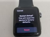 an apple watch sitting on top of a table with a message on the screen