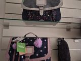 two bags that are on a shelf in a store
