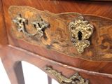 a close up of a wooden table with a drawer on it