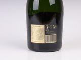 bottle of wine on a white surface with a label on it