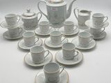 many cups and saucers arranged in a circle on the table