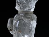 a glass bear that is sitting on top of a table