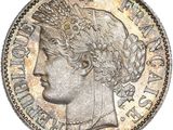 a silver coin with a crown on top of it