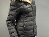 the jacket is black and has a fur collar and cuffs