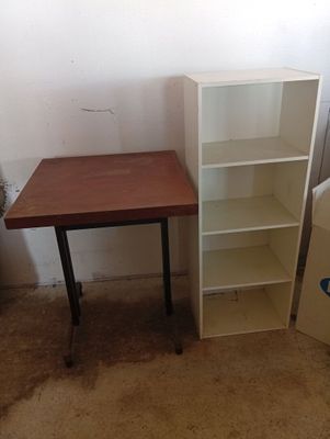 a small table and a bookcase in a room