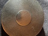 a metal object that is sitting on a cloth