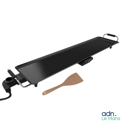 an image of a grill with a spatula on it