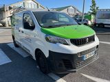 a green and white van parked in a parking lot