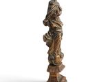 a statue of a woman holding a basket of flowers on top of a pedestal
