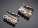 pair of silver plated hair combs with spikes on each side