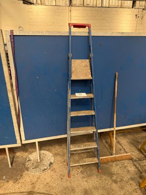 a ladder leaning against a blue wall in a room